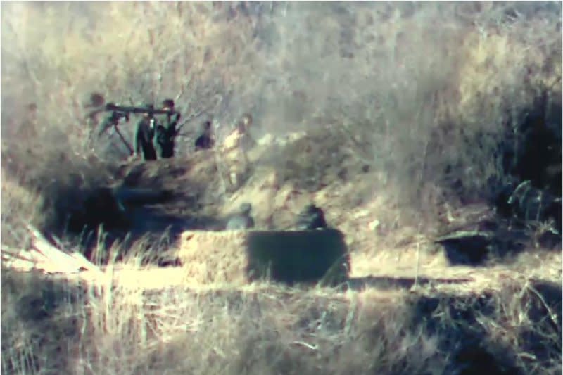 North Korean soldiers are spotted moving heavy firearms into a guard post inside the Demilitarized Zone separating the two Koreas on Friday. Photo courtesy of South Korean Defense Ministry/Yonhap