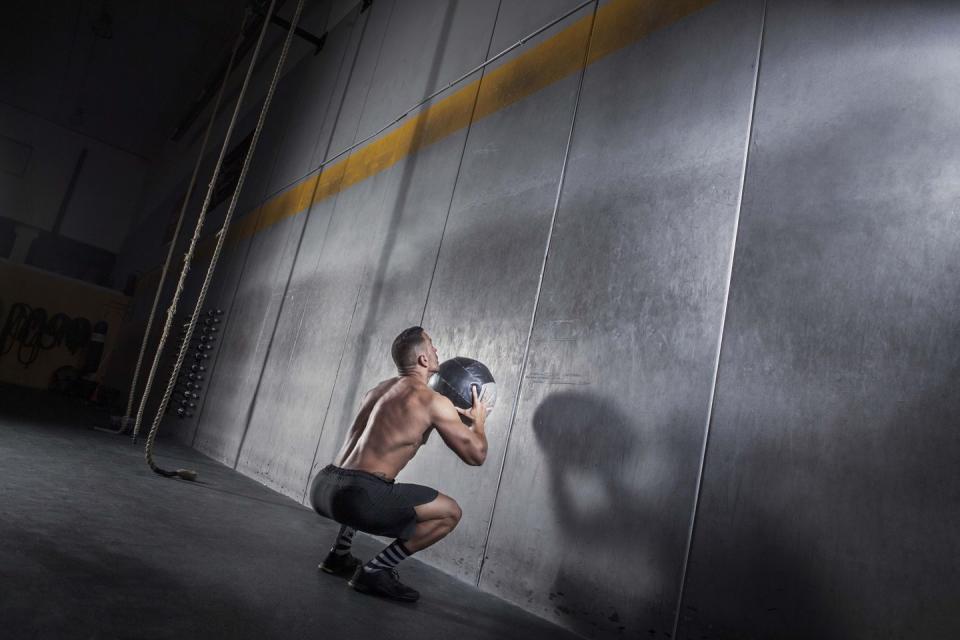 wall ball man exercising