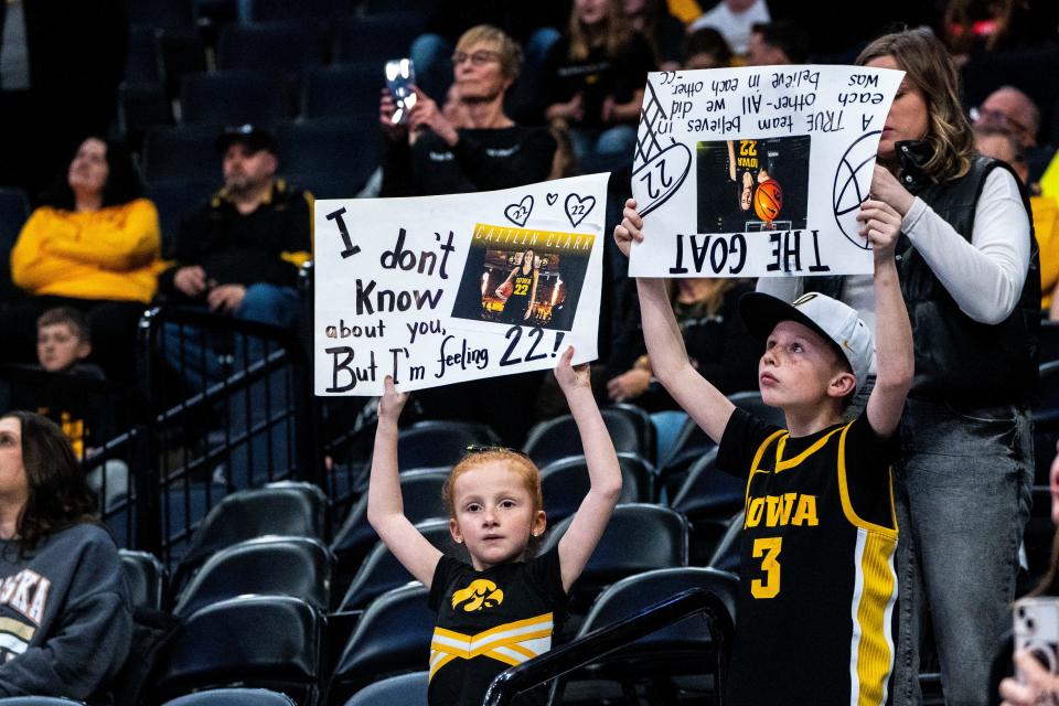 Fans hold signs during the Big Ten Women's Basketball tournament quarterfinals at the Target Center on Friday, March 8, 2024, in Minneapolis, Minn.