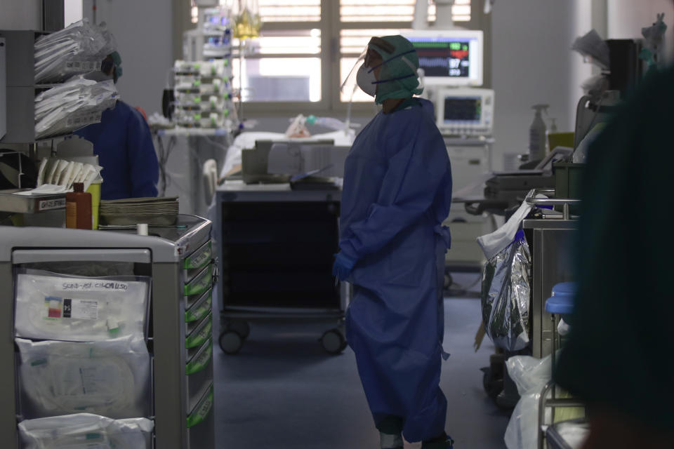 In this March 16, 2020, photo, doctors work in the intensive care unit of the Brescia hospital, Italy. Hospitals in northern Italy are struggling to make room for the onslaught of coronavirus patients. (AP Photo/Luca Bruno)