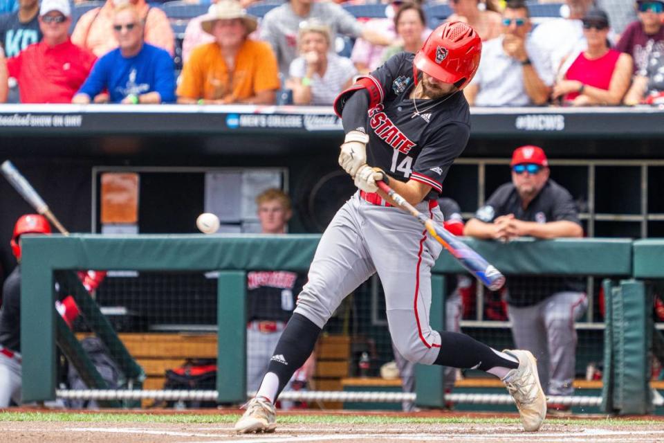 NC State Wolfpack catcher Jacob Cozart (14) hits a single against the Kentucky Wildcats during the first inning at Charles Schwab Field Omaha.