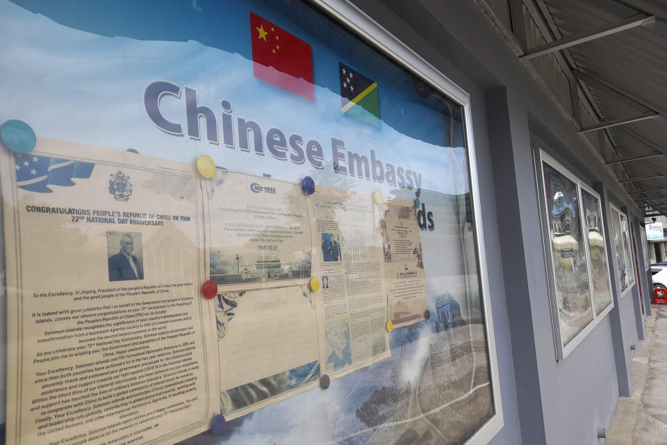 FILE - A display case of photos is seen outside the Chinese Embassy in Honiara, Solomon Islands on April 2, 2022. China’s Foreign Minister Wang Yi is visiting the South Pacific with a 20-person delegation this week in a display of Beijing's growing military and diplomatic presence in the region. (AP Photo/Charley Piringi, File)