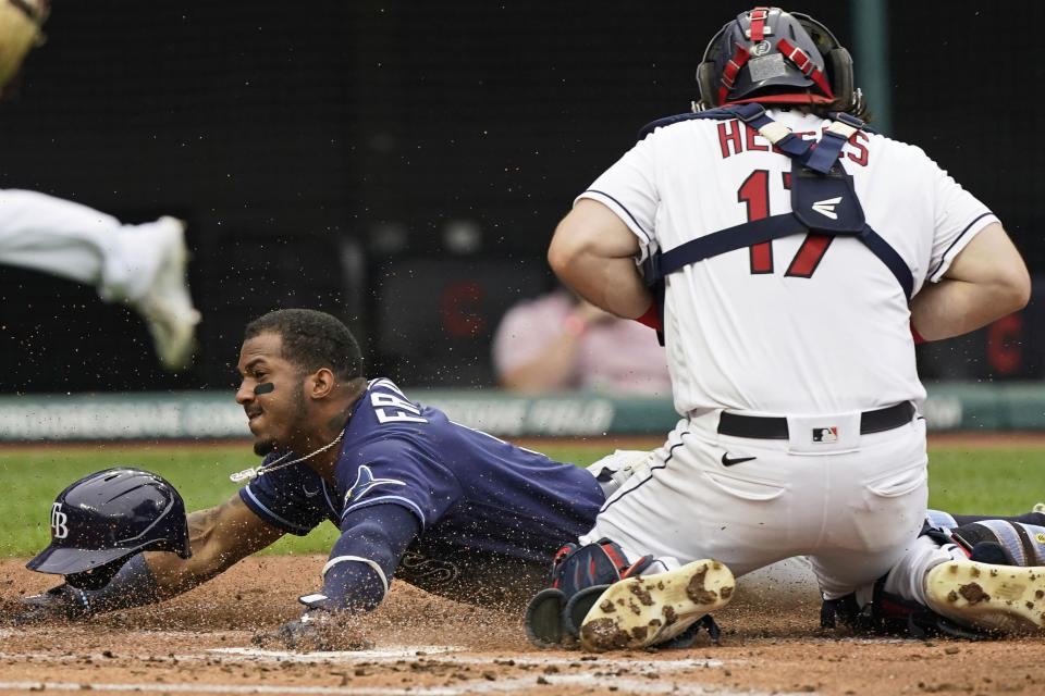 Tampa Bay Rays' Wander Franco scores as Cleveland Indians catcher Austin Hedges gathers in the throw during the second inning of a baseball game Friday, July 23, 2021, in Cleveland. (AP Photo/Tony Dejak)