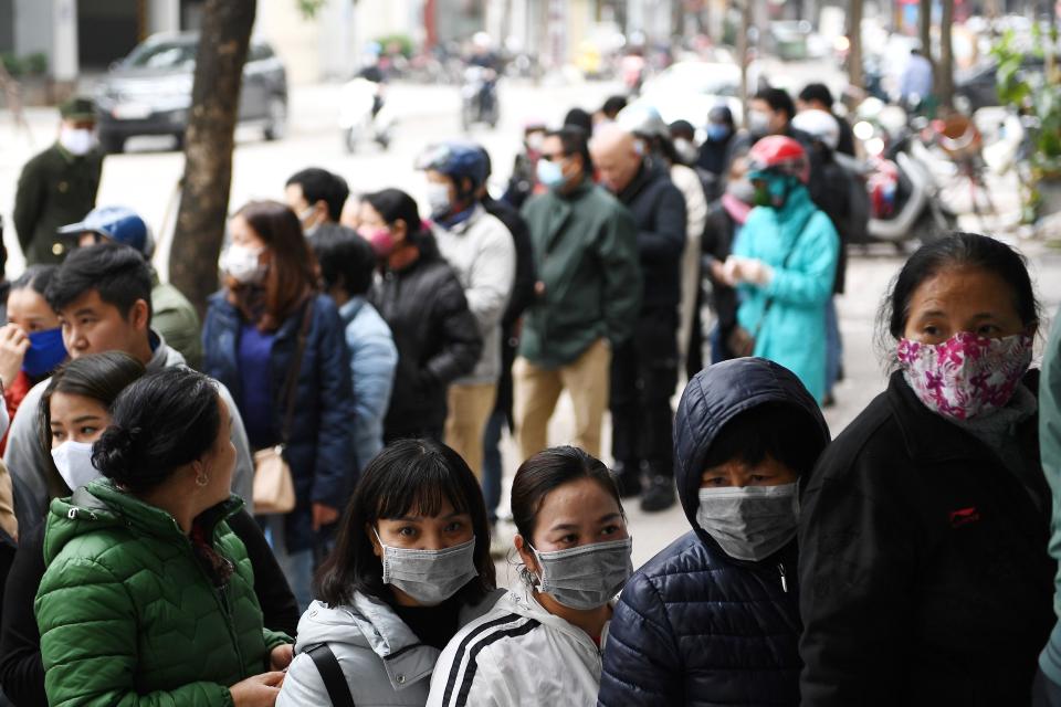 People line up to buy protective face masks amid concerns of the novel coronavirus outbreak that originated in central China, outside a shop in Hanoi on February 10, 2020. - Vietnam repatriated 30 citizens February 10 from Wuhan, where the SARS-like novel coronavirus originated. (Photo by Nhac NGUYEN / AFP) (Photo by NHAC NGUYEN/AFP via Getty Images)