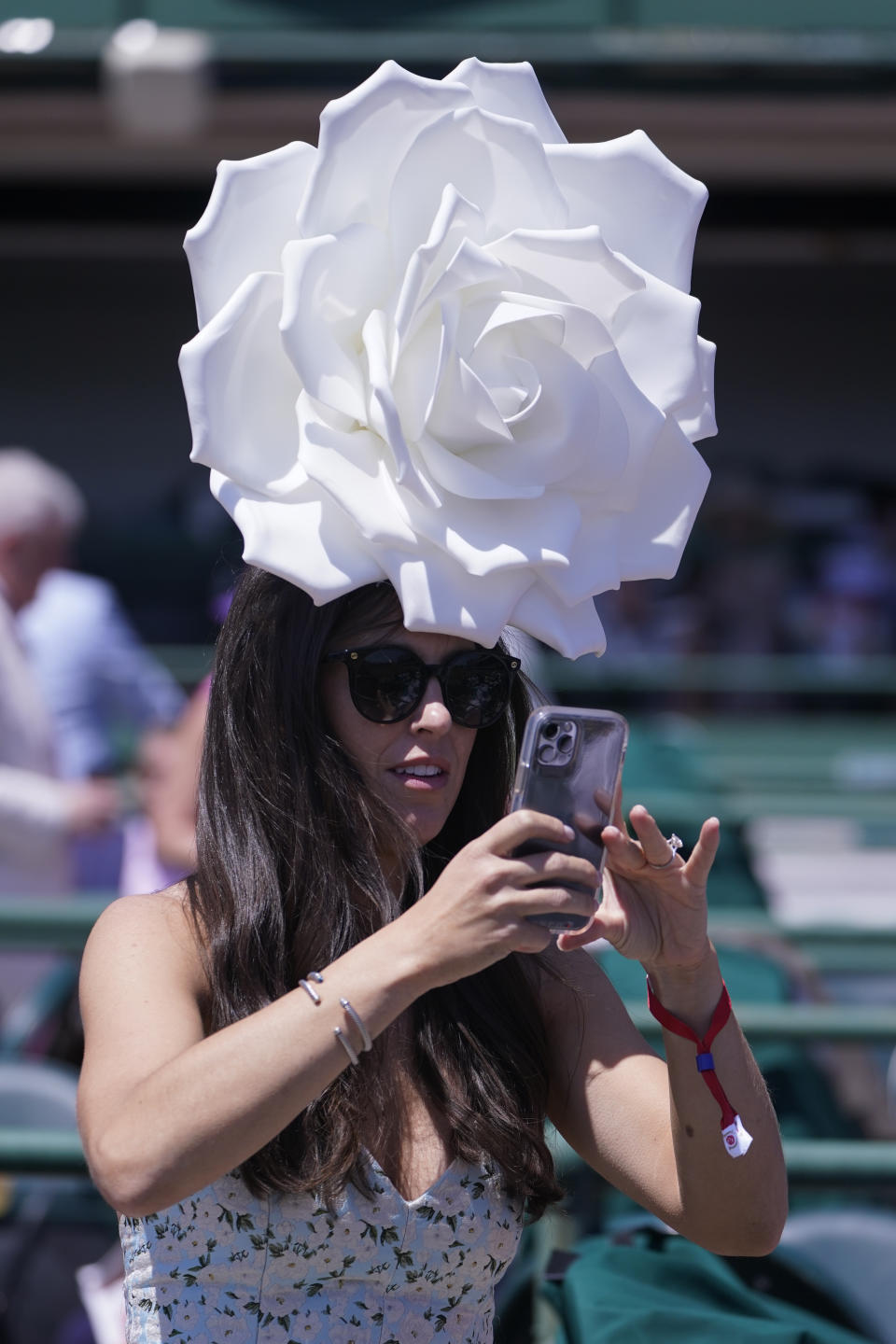 A woman takes a photo before the 147th running of the Kentucky Derby at Churchill Downs, Saturday, May 1, 2021, in Louisville, Ky. (AP Photo/Michael Conroy)