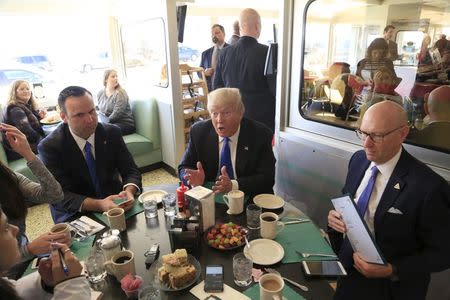 U.S. Republican presidential candidate Donald Trump talks with the media as he stops in for breakfast at Miss Katie's Diner, while campaigning in Milwaukee, Wisconsin April 3, 2016. REUTERS/Darren Hauck