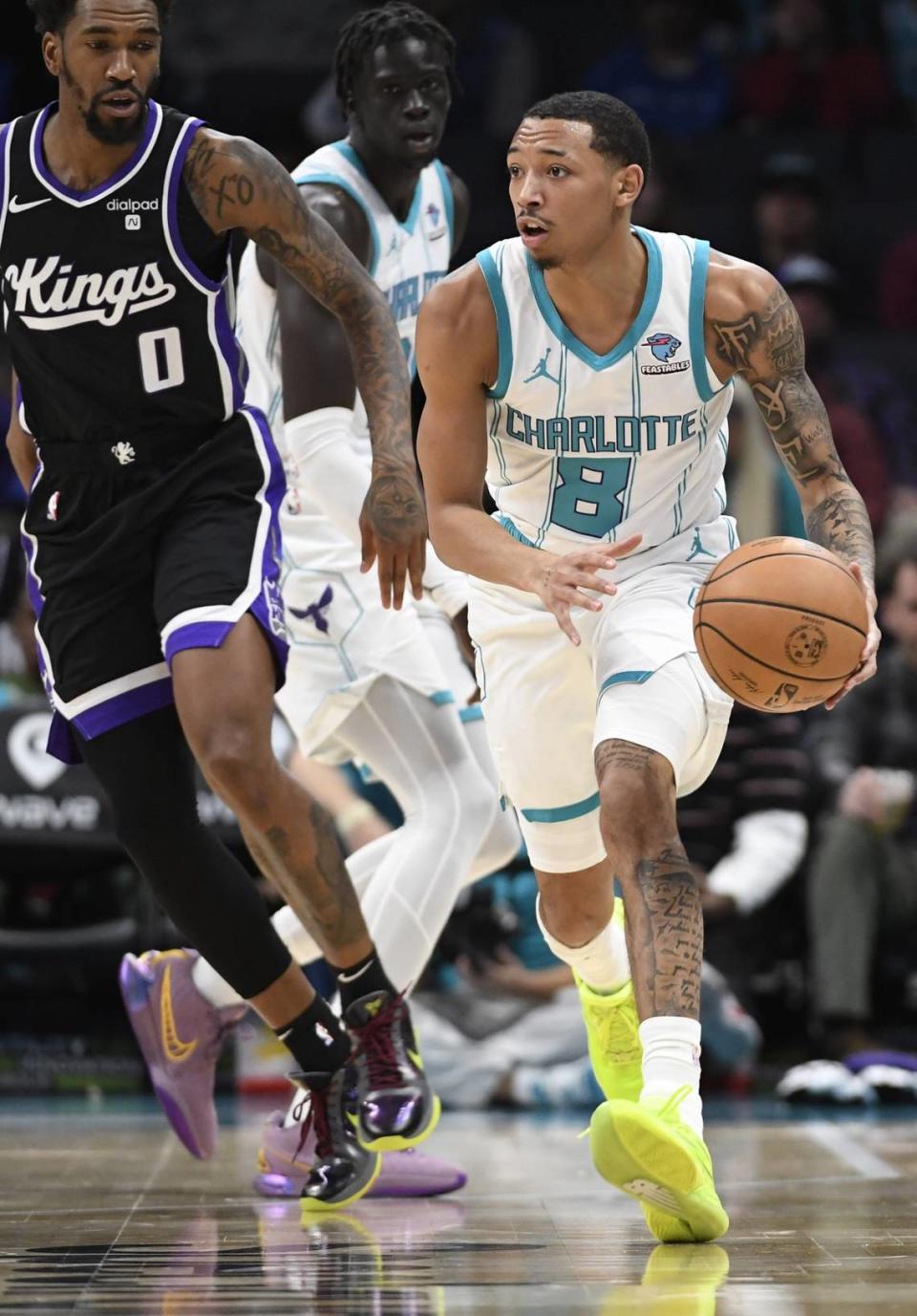 Jan 10, 2024; Charlotte, North Carolina, USA; Charlotte Hornets guard Nick Smith Jr. (8) drives past Sacramento Kings guard Malik Monk (0) during the first half at the Spectrum Center. Mandatory Credit: Sam Sharpe-USA TODAY Sports