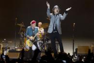 Mick Jagger, right and Keith Richards, left, and Charlie Watts behind, of The Rolling Stones perform at the O2 arena in east London, Sunday, Nov. 25, 2012. The band are playing four gigs to celebrate their 50th anniversary, including two shows at London’s O2 and two more in New York. (Photo by Joel Ryan/Invision/AP)