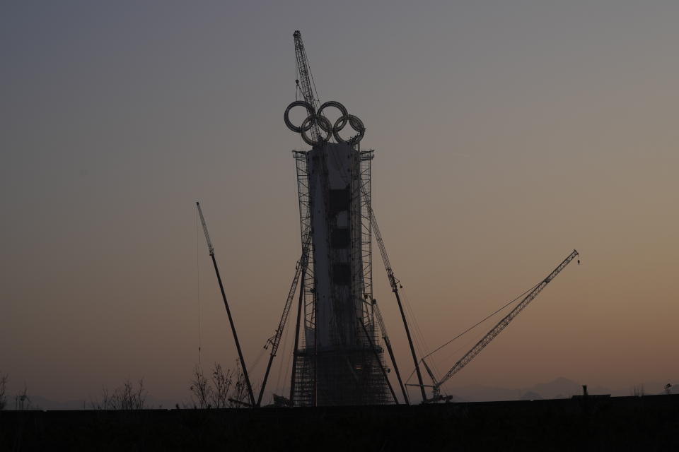 The Olympic Rings on a tower is constructed for the Beijing Winter Olympics 2022 to be held in Beijing, China, Wednesday, Jan. 5, 2022. China has undergone history-making change since the last time it was an Olympic host in 2008: It is richer, more heavily armed and openly confrontational. (AP Photo/Ng Han Guan)