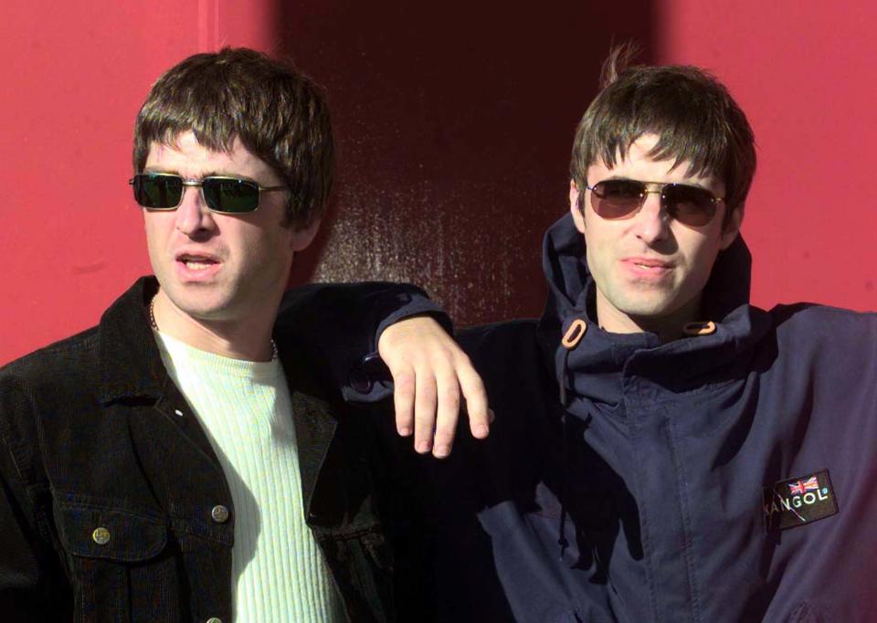 Liam Gallagher (R) and his songwriting brother Noel walk out of the concert hall for a photo-opportunity prior to the first date on their 1997 UK tou, September 13. Oasis's new record has gone straight to number one in the UK charts.    BRITAIN OASIS