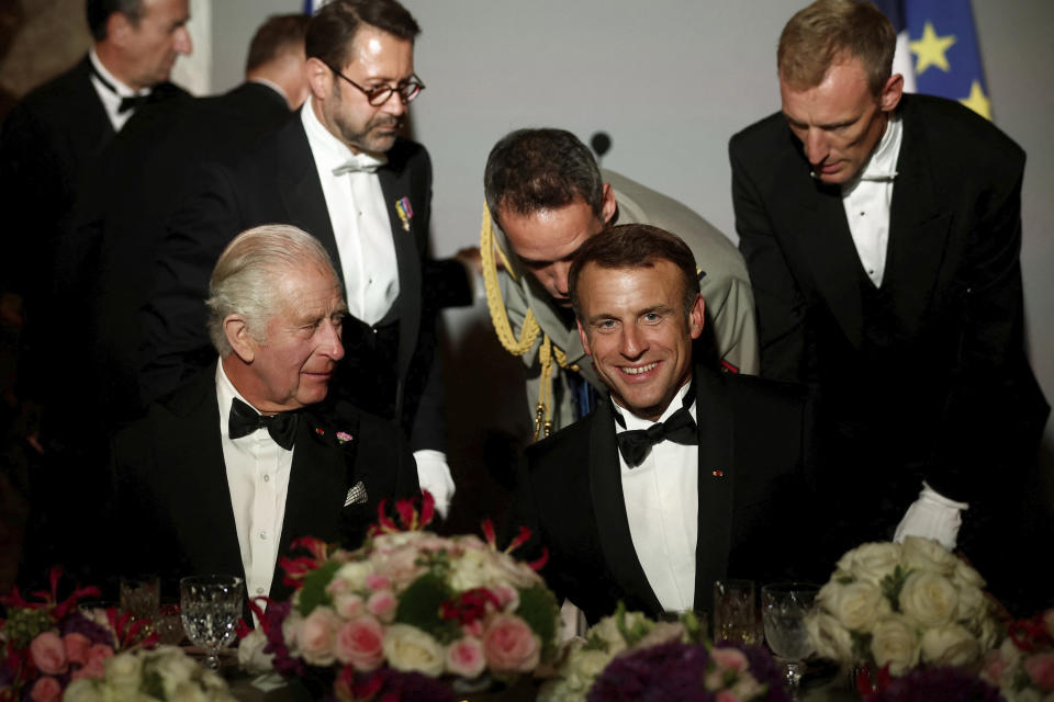 French President Emmanuel Macron, right, and Britain's King Charles III attend a state dinner in the Hall of Mirrors at the Chateau de Versailles, west of Paris, Wednesday, Sept. 20, 2023 in Versailles. President Emmanuel Macron and King Charles III held talks in Paris on Wednesday at the start of a long-awaited three-day state visit meant to highlight the friendship between France and the U.K. (Benoit Tessier/Pool via AP)