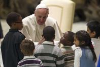 Pope Francis greets children assisted by volunteers of Santa Marta institute during an audience in Paul VI hall at the Vatican December 14, 2013. REUTERS/Giampiero Sposito (VATICAN - Tags: RELIGION)