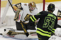 Vegas Golden Knights goaltender Jonathan Quick (32) blocks a shot by Dallas Stars center Wyatt Johnston (53) during the first period of an NHL hockey game in Dallas, Saturday, April 8, 2023. (AP Photo/LM Otero)