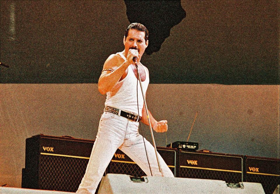 LONDON, UNITED KINGDOM - JULY 13: Freddie Mercury of Queen performs on stage at Live Aid on July 13th, 1985 in Wembley Stadium, London, England (Photo by Pete Still/Redferns)