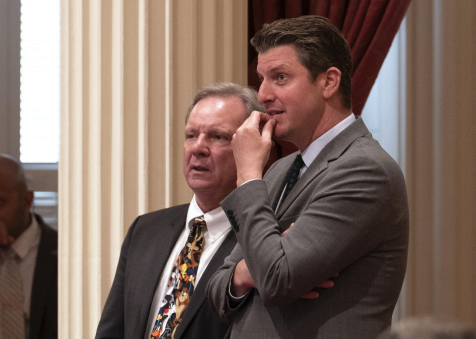 Democratic state Senators Dave Cortese of San Jose, left, and Henry Stern of Los Angeles watch as votes are posted on a bill before the Senate at the Capitol in Sacramento, Calif., Tuesday, Sept. 12, 2023. Lawmakers are expected to vote on Stern's measure, SB261, that would require companies making $500 million annually to disclose how much climate change affects their business. Lawmakers are voting on hundreds of bills before the legislative session concludes for the year on Thursday. (AP Photo/Rich Pedroncelli)