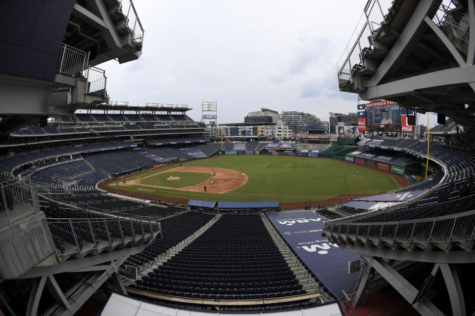 In this photo taken with a fisheye lens, the Toronto Blue Jays and the Washington Nationals compete during the fifth inning of a baseball game Thursday, July 30, 2020, in Washington. (AP Photo/Nick Wass)