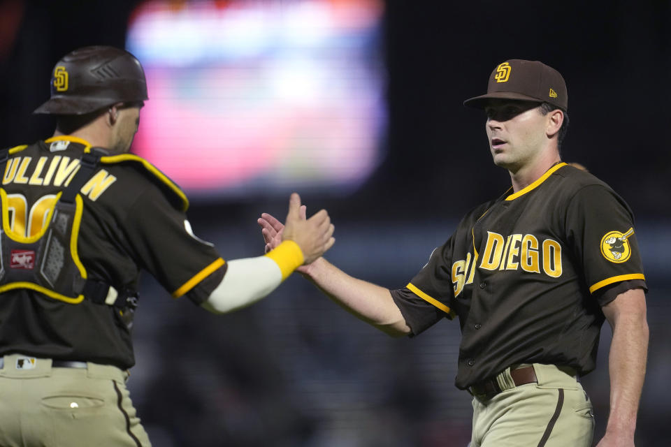 San Diego Padres catcher Brett Sullivan, left, celebrates with pitcher Tom Cosgrove after the Padres defeated the San Francisco Giants in a baseball game in San Francisco, Wednesday, Sept. 27, 2023. The Padres won 5-2 in 10 innings. (AP Photo/Jeff Chiu)