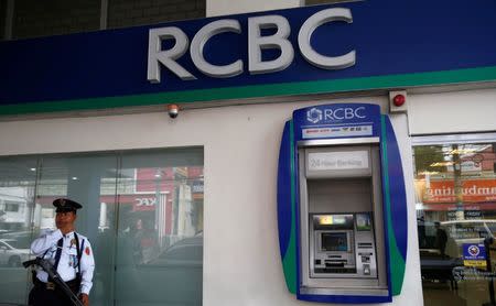 A security guard stands guard outside a branch of Rizal Commercial Banking Corporation (RCBC) in Paranaque city, Metro Manila, Philippines August 2, 2016. REUTERS/Erik De Castro