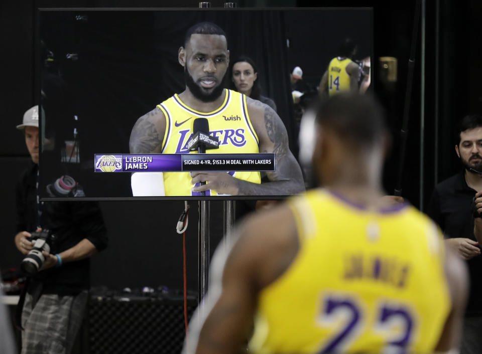 Los Angeles Lakers' LeBron James appears on a television screen as he answers questions during media day at the NBA basketball team's practice facility Monday, Sept. 24, 2018, in El Segundo, Calif. (AP Photo/Marcio Jose Sanchez)