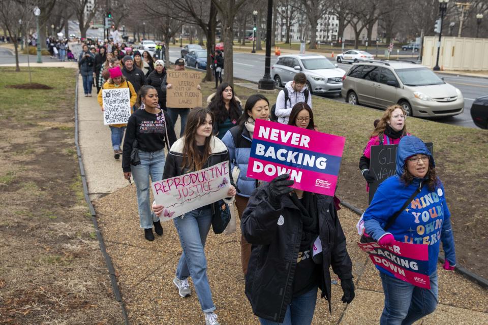 People demonstrating in the Women's March, which largely focused on abortion rights, walk towards the Supreme Court building in Washington, Sunday, Jan. 22, 2023. (AP Photo/Amanda Andrade-Rhoades)