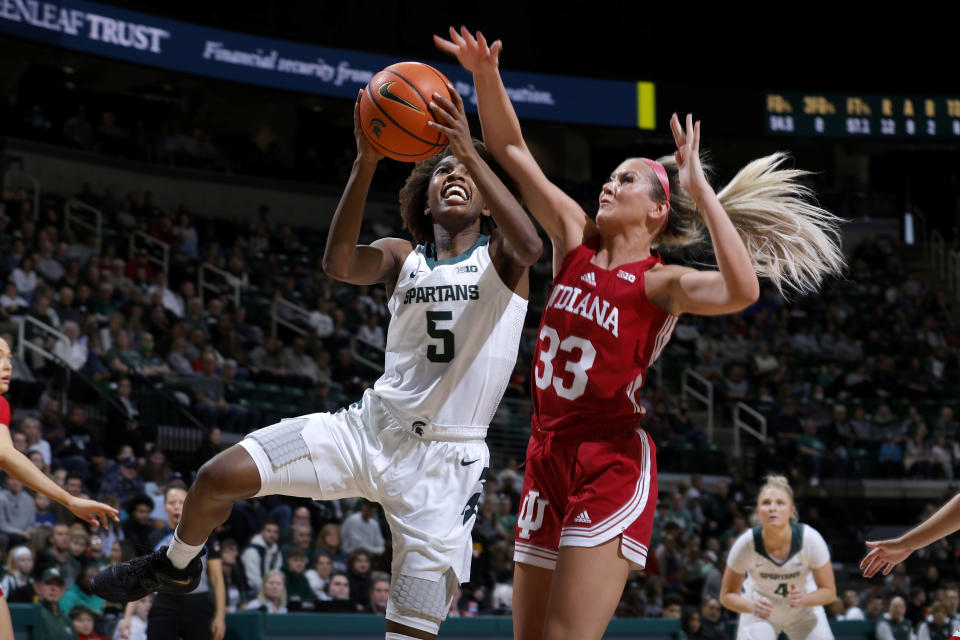 Michigan State's Kamaria McDaniel, left, shoots against Indiana's Sydney Parrish (33) during the first half of an NCAA college basketball game on Thursday, Dec. 29, 2022, in East Lansing, Mich. (AP Photo/Al Goldis)