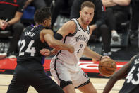 Toronto Raptors' Khem Birch (24) defends against Brooklyn Nets' Blake Griffin during the second half of an NBA basketball game Wednesday, April 21, 2021, in Tampa, Fla. (AP Photo/Mike Carlson)