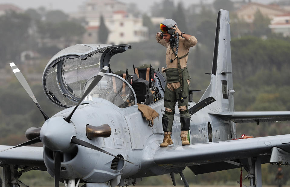 FILE - In this October 31, 2017 file photo, a Lebanese pilot disembarks from a one of six Super Tucano A29 warplanes that handed by the United State to the Lebanese military as part of military aid program, after he finished an air performance, at Hamat military air base, in north Lebanon. The currency collapse has wiped out the salaries of the U.S.-backed Lebanese military, placed unprecedented pressure on the army's operational capabilities with some of the highest attrition rates over the past two years, and raised concerns about its ability to continue playing a stabilizing role while sectarian tensions and crime are on the rise.(AP Photo/Hussein Malla, File)