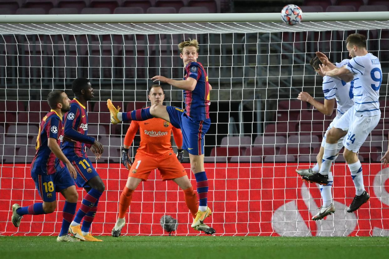 Dynamo Kiev's Polish defender Tomasz Kedziora (R) heads the ball during the UEFA Champions League group G football match between Barcelona and Dynamo Kiev at the Camp Nou stadium in Barcelona, on November 4, 2020. (Photo by LLUIS GENE / AFP) (Photo by LLUIS GENE/AFP via Getty Images)