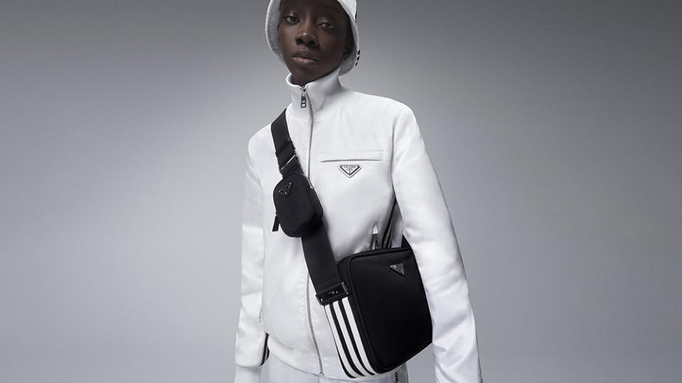 An all-white fit with a three-stripe messenger bag from the collab. - Credit: Adidas