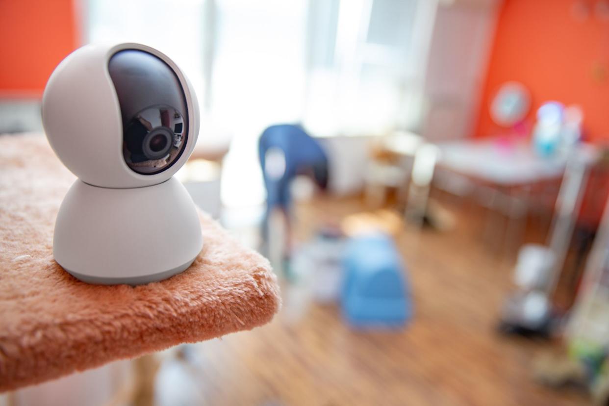 Home Security System on a Shelf Protecting and Recording Young Family - Stock Photo