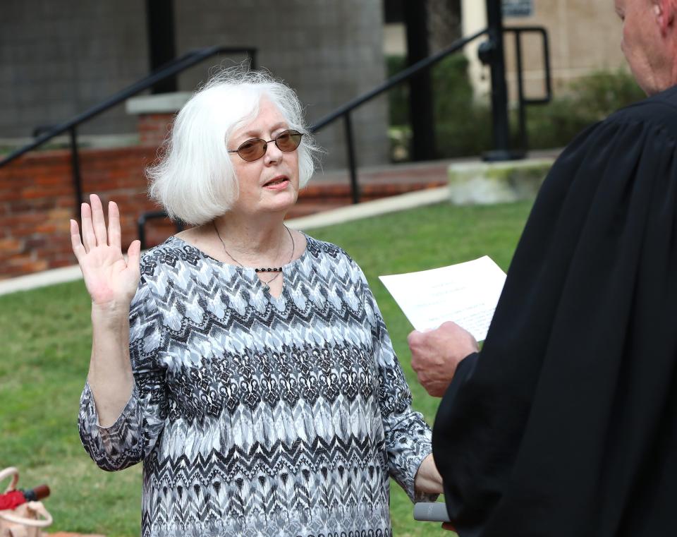Mildred Russell, who was instated by Gov. Ron DeSantis to the Alachua County School Board to fill the District 2 seat left vacant when Dyionne McGraw was removed from the board in June, is sworn into her seat by Circuit Judge Robert Groeb, in Gainesville Fla. Aug. 26, 2021.