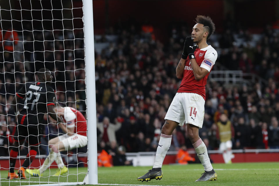 Arsenal's Pierre-Emerick Aubameyang, right, reacts after a missed scoring opportunity during the Europa League round of 16, 2nd leg, soccer match between Arsenal and Rennes at the Emirates stadium in London, Thursday, March 14, 2019. (AP Photo/Alastair Grant)