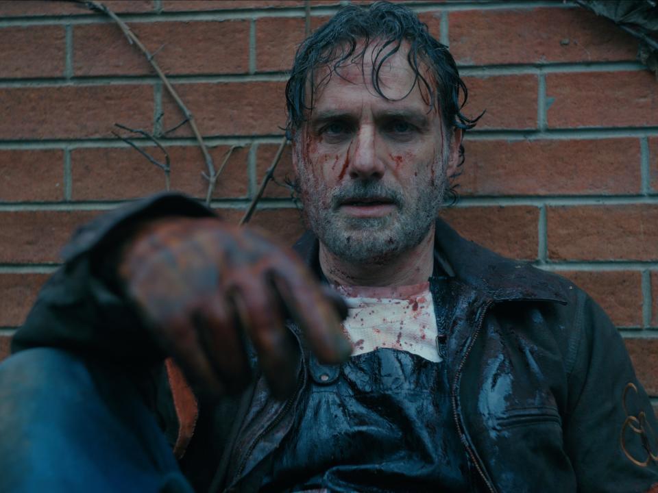 Andrew Lincoln sitting while covered in blood and sweat on "TWD: The Ones Who Live."