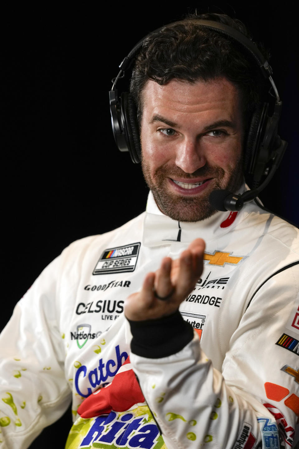 Corey LaJoie takes part in an interview during NASCAR Daytona 500 auto racing media day at Daytona International Speedway, Wednesday, Feb. 14, 2024, in Daytona Beach, Fla. (AP Photo/John Raoux)