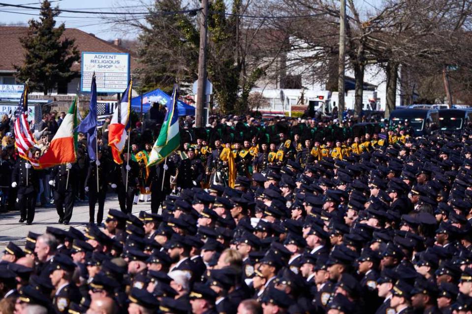 A crowd of police officers paying respects to Diller outside the church. James Keivom