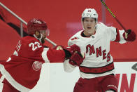 Detroit Red Wings defenseman Patrik Nemeth (22) checks Carolina Hurricanes center Martin Necas (88) in the first period of an NHL hockey game Thursday, Jan. 14, 2021, in Detroit. (AP Photo/Paul Sancya)