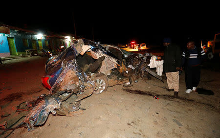 People look at the wreckage of a car involved in an accident after a fireball from a tanker engulfed several vehicles and killed several people, near the Rift Valley town of Naivasha, west of Kenya's capital Nairobi, December 11, 2016. REUTERS/Thomas Mukoya