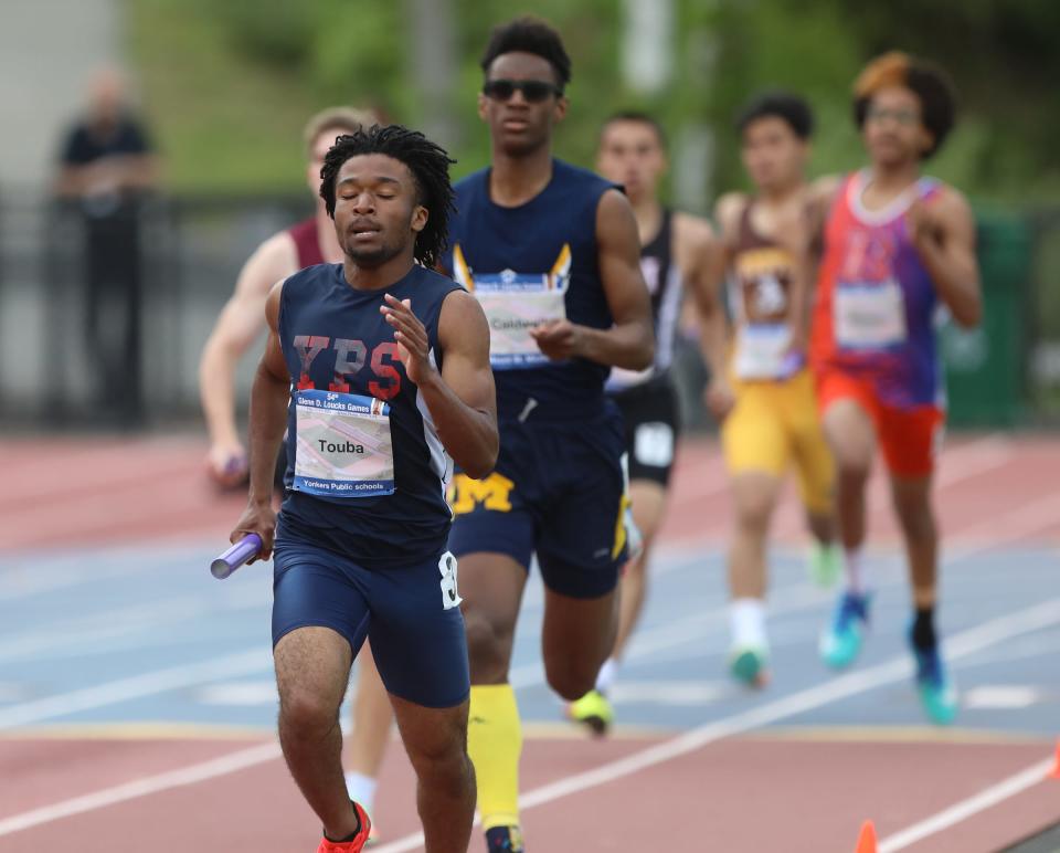 Derrick Touba runs the opening leg for Yonkers during the boys Nick Panera 4x400-meter relay at the 54th annual Loucks Games on Friday at White Plains High School. Yonkers won in a season-best 3:29.05.