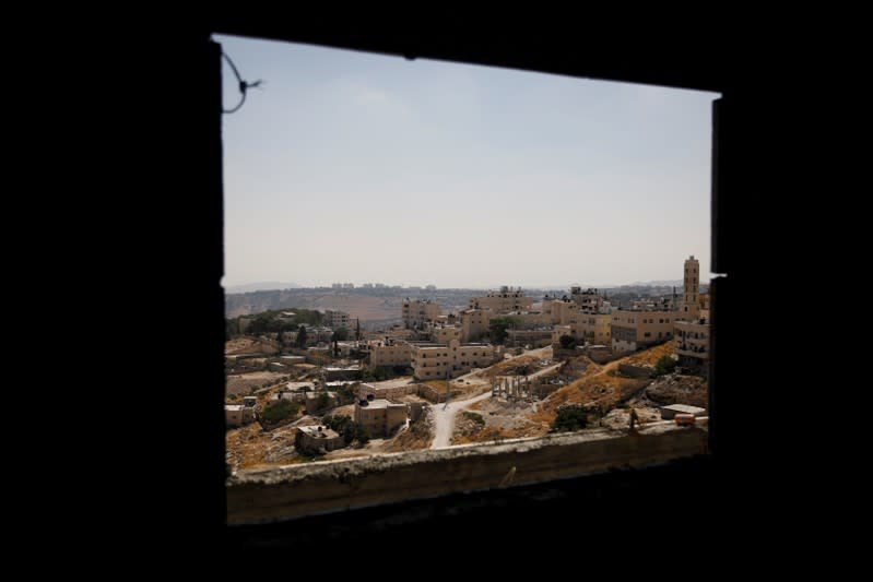 FILE PHOTO: A view shows Palestinian houses in al-Eizariya village, close to the Jewish settlement of Maale Adumim, in the Israeli-occupied West Bank