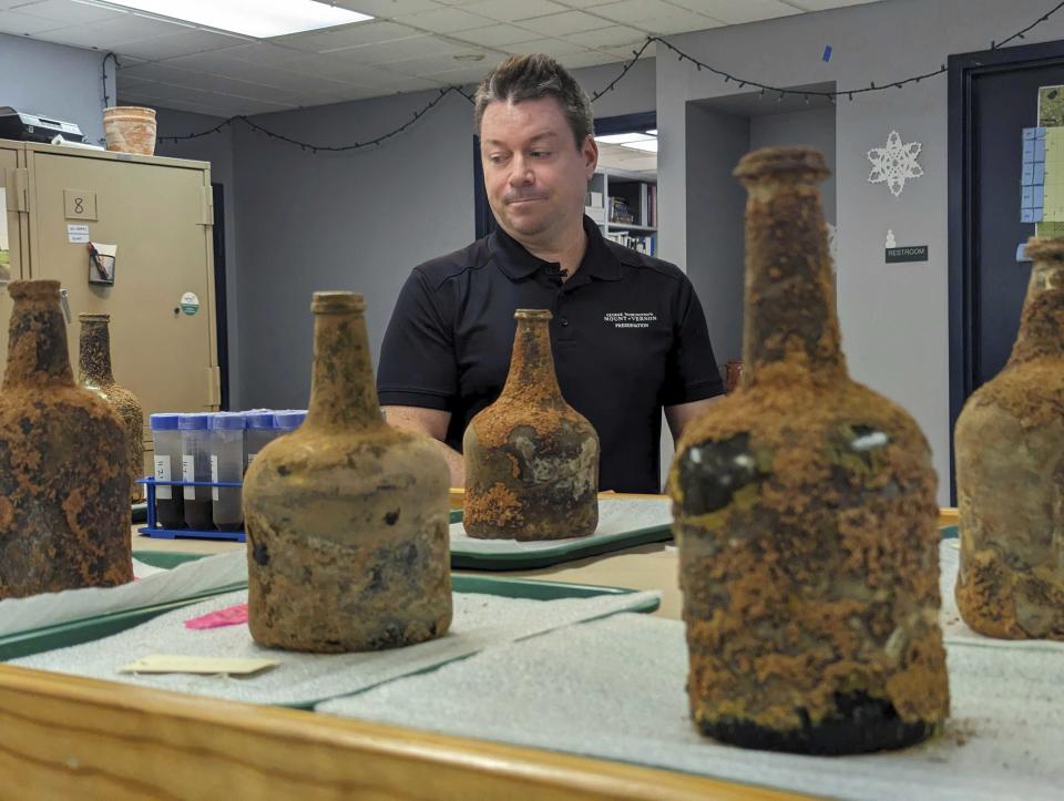 Archeologist Jason Boroughs discusses artifacts found underneath George Washington's residence in Mount Vernon, Va., Monday, June 17, 2024. Earlier this year, a few dozen 18th-century glass bottles containing fruit were unearthed in the mansion cellar of the America's first president.(AP Photo/Nathan Ellgren)