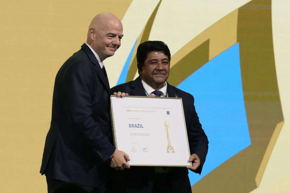 FIFA President Gianni Infantino, left, gives the certificate to President of the Football Associated of Brazil Ednaldo Rodrigues, right, after announcing that Brazil is chosen to host the 2027 Women's World Cup soccer at the FIFA Congress in Bangkok, Thailand, Friday, May 17, 2024.(AP Photo/Sakchai Lalit)