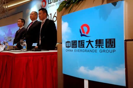 (L-R) China Evergrande Group CFO Pan Darong, CEO Xia Haijun and Executive Vice President of Financial Group Tse Wai-wah attend a news conference on the company's interim results in Hong Kong, China August 30, 2016. REUTERS/Bobby Yip