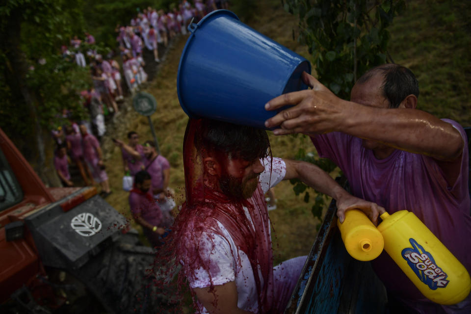 <p>A man has red wine thrown on him as he takes part in a wine battle, in the small village of Haro, northern Spain, Friday, June 29, 2018. (Photo: Alvaro Barrientos/AP) </p>