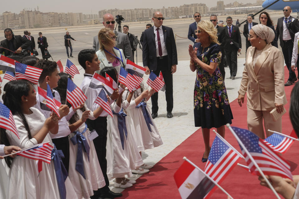 First Lady Jill Biden, center, accompanied by Egyptian First Lady Entissar Mohameed Amer is greeted by children as she arrives at Cairo International Airport in Cairo, Friday, June 2, 2023. (AP Photo/Amr Nabil, Pool)