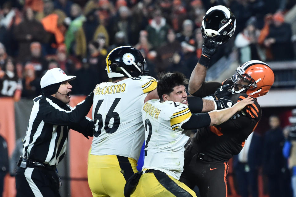 Nov 14, 2019; Cleveland, OH, USA; Cleveland Browns defensive end Myles Garrett (95) hits Pittsburgh Steelers quarterback <a class="link " href="https://sports.yahoo.com/nfl/players/31046" data-i13n="sec:content-canvas;subsec:anchor_text;elm:context_link" data-ylk="slk:Mason Rudolph;sec:content-canvas;subsec:anchor_text;elm:context_link;itc:0">Mason Rudolph</a> (2) with his own helmet as offensive guard <a class="link " href="https://sports.yahoo.com/nfl/players/25734" data-i13n="sec:content-canvas;subsec:anchor_text;elm:context_link" data-ylk="slk:David DeCastro;sec:content-canvas;subsec:anchor_text;elm:context_link;itc:0">David DeCastro</a> (66) tries to stop Garrett during the fourth quarter at FirstEnergy Stadium. Mandatory Credit: Ken Blaze-USA TODAY Sports