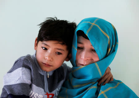 Murtaza Ahmadi, 7, an Afghan Lionel Messi fan and his mother Shafiqa Ahmadi, 38, pose for a picture at their house in Kabul, Afghanistan December 8, 2018.REUTERS/Mohammad Ismail