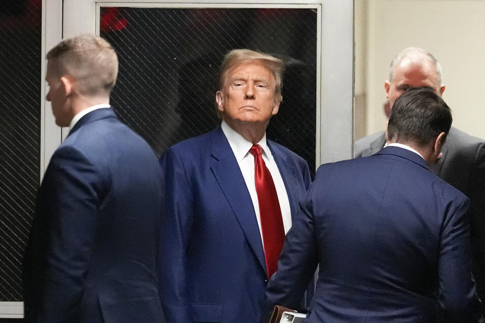 Former President Donald Trump, center, leaves a pre-trial hearing during a recess with his defense team at Manhattan criminal, Monday, March 25, 2024, in New York. A judge will weigh on Monday when the former president will go on trial. (AP Photo/Mary Altaffer, Pool)