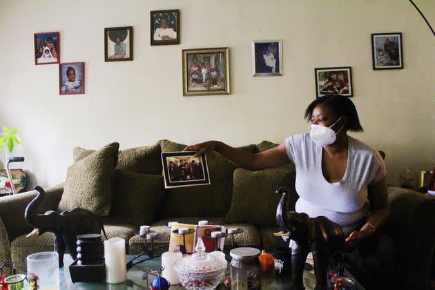 Priscilla Geter, 57, shows a picture of her family, including her daughter, Schacana Geter, 34, who was at the grocery store at the time of the shooting. (Photo: Phillip Jackson/HuffPost)