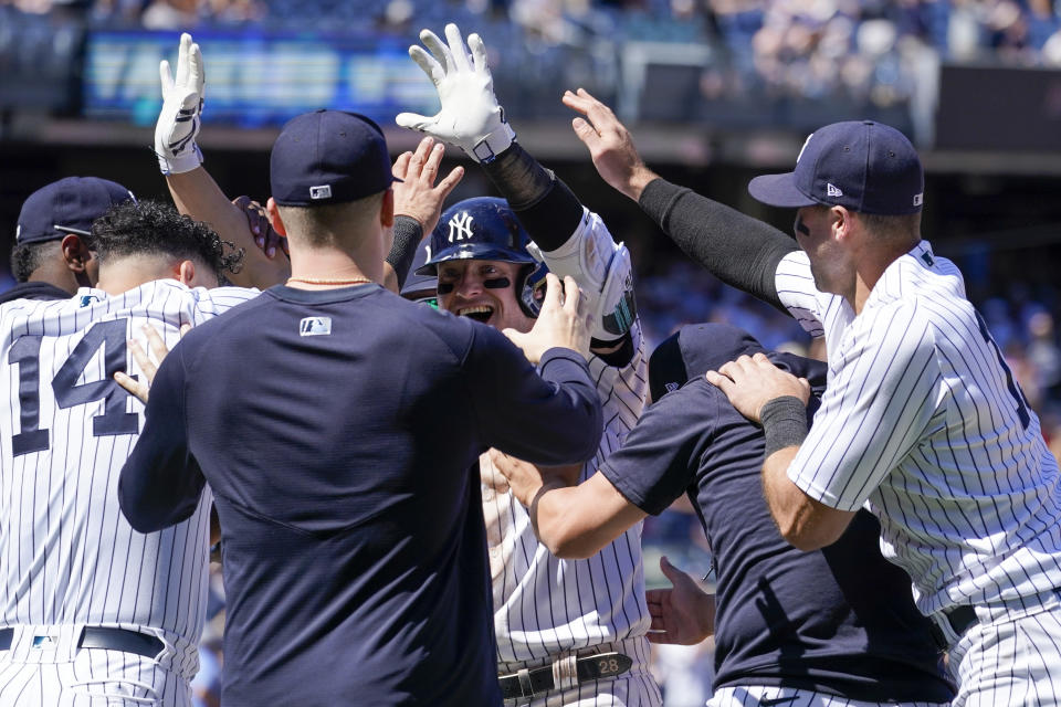 New York Yankees' Josh Donaldson, center, celebrate with his teammates after hitting the game winning sacrifice fly in the tenth inning of a baseball game against the Detroit Tigers, Sunday, June 5, 2022, in New York. (AP Photo/Mary Altaffer)