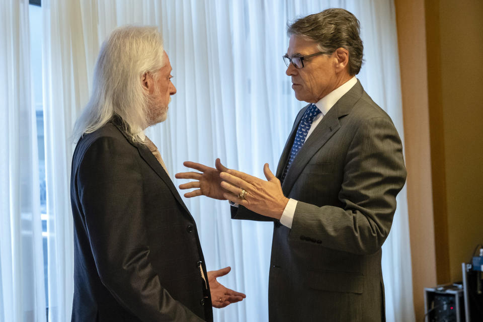 In this Nov. 12, 2018, photo provided by the U.S. Embassy in Kyiv, Energy Secretary Rick Perry talks with Michael Bleyzer during a speech in Kyiv, Ukraine. Bleyzer and Alex Cranberg, two political supporters of Perry secured a potentially lucrative oil-and-gas exploration deal from the Ukrainian government soon after Perry proposed one of the men as an adviser to the country’s new president. (U.S. Embassy Kyiv via AP)